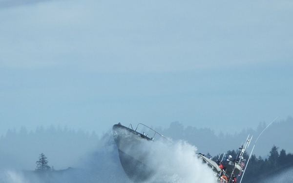 Petty Officer 2nd Class Enrique Lemos operates in the surf