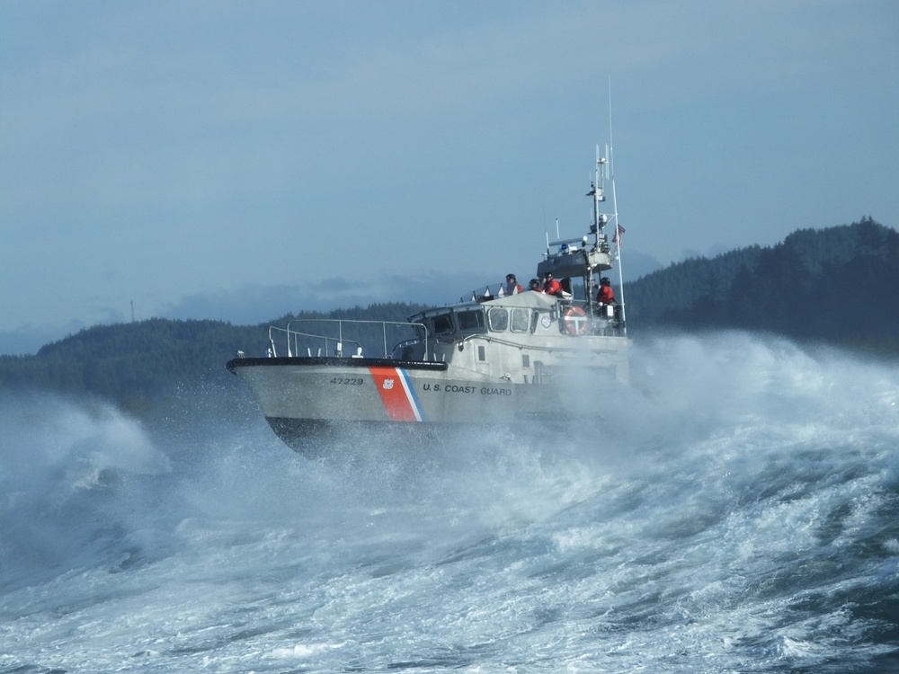 Petty Officer 2nd Class Enrique Lemos operates in the surf near Winchester Bay, Oregon