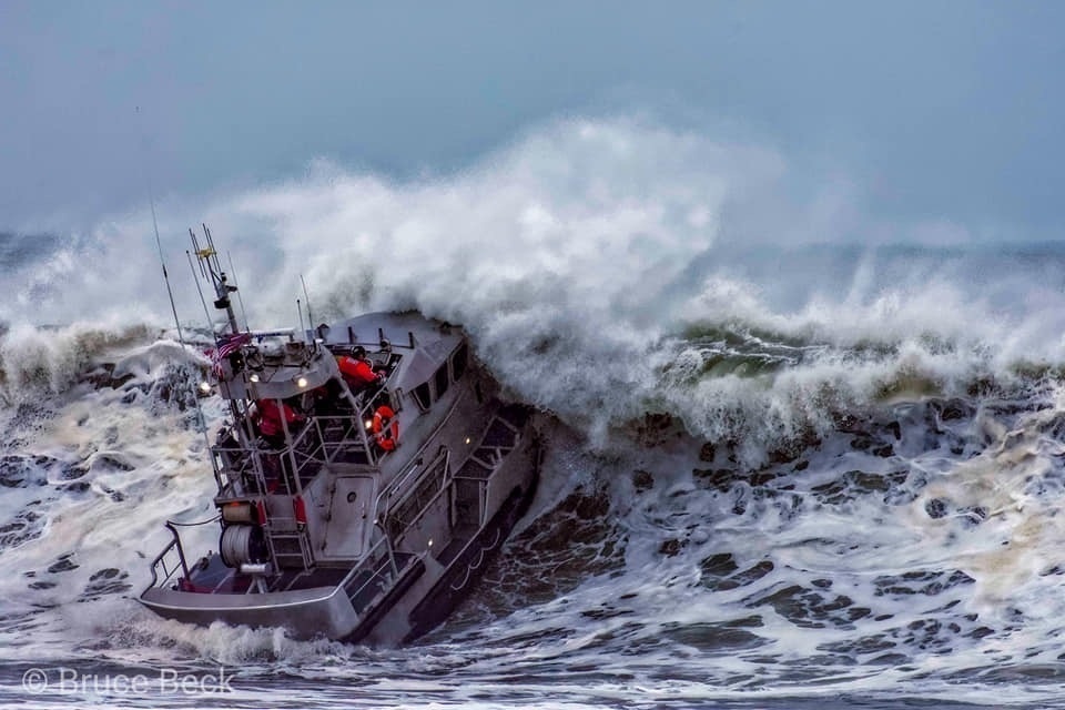 Petty Officer 1st Class Adam Preiser operates in the surf near Brookings, Oregon
