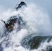 Petty Officer 1st Class Adam Presier operates in the surf near Brookings, Oregon
