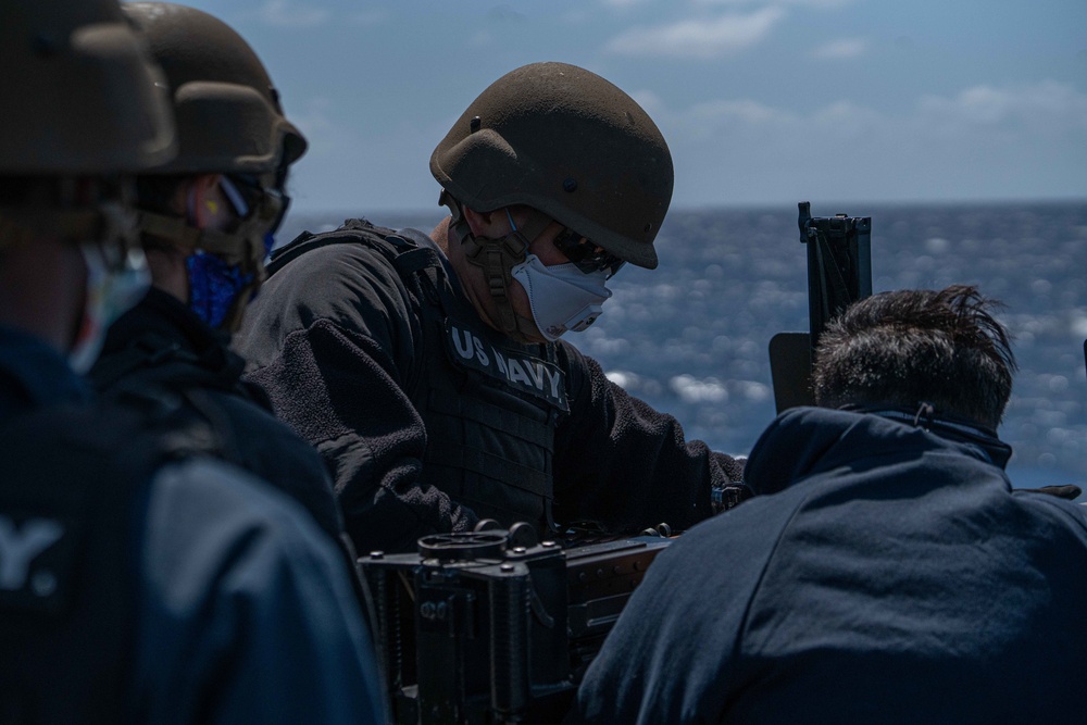 Sailor operates a .50 caliber gun aboard USS Halsey