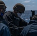 Sailor operates a .50 caliber gun aboard USS Halsey