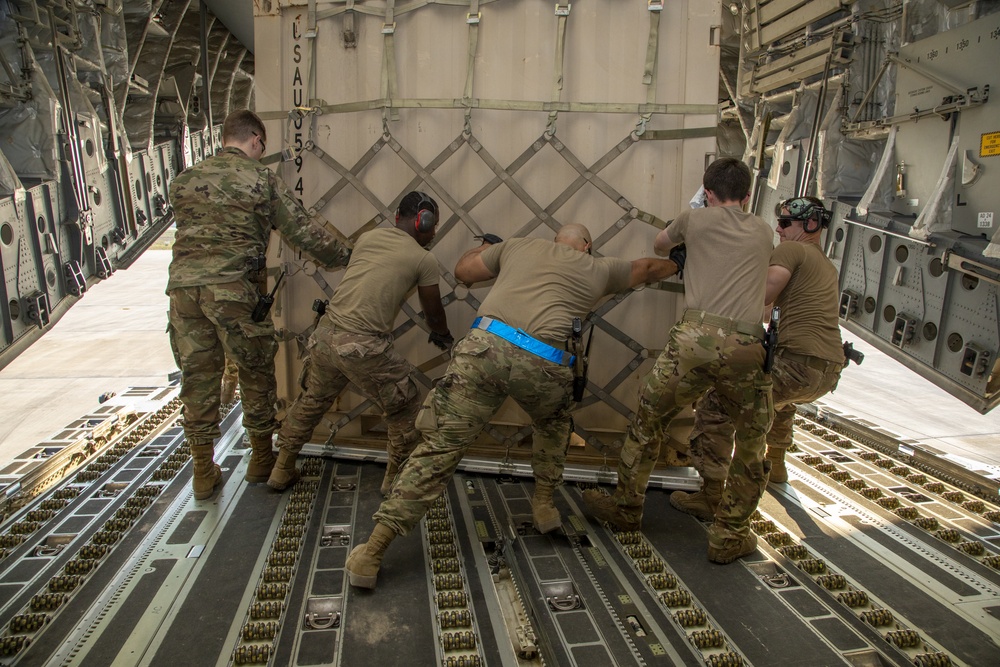 U.S. Airmen unload cargo from C-17 Globemaster III