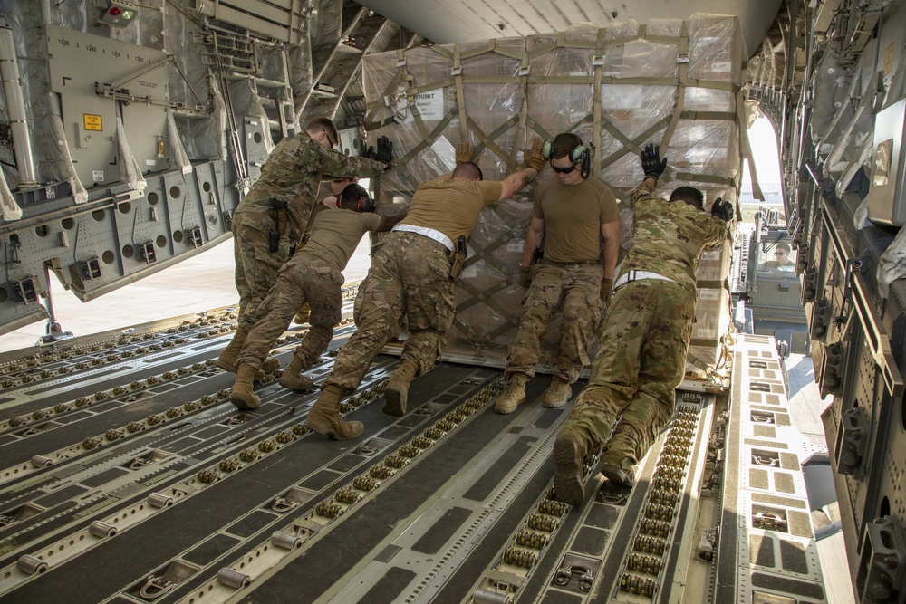 U.S. Airmen unload cargo from C-17 Globemaster III