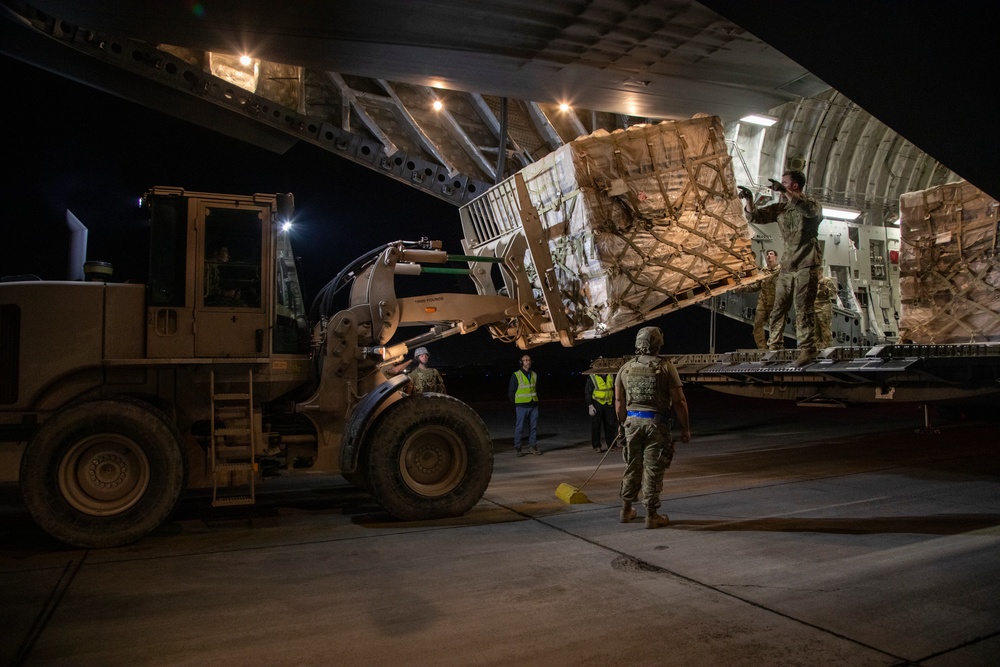 U.S. Airmen unload cargo from C-17 Globemaster III