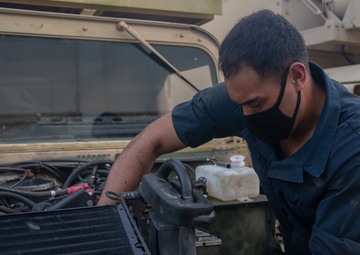 U.S. Marines perform maintenance on a fleet of tactical vehicles