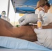 Navy Corpsmen with U.S. Naval Hospital Guam take samples from Sailors attached to USS Theodore Roosevelt for a CDC Study
