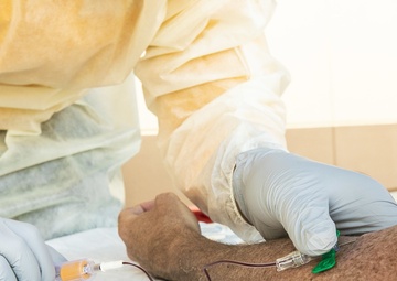 Navy Corpsmen with U.S. Naval Hospital Guam take samples from Sailors attached to USS Theodore Roosevelt for a CDC Study