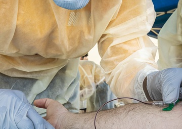 Navy Corpsmen with U.S. Naval Hospital Guam take samples from Sailors attached to USS Theodore Roosevelt for a CDC Study