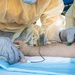 Navy Corpsmen with U.S. Naval Hospital Guam take samples from Sailors attached to USS Theodore Roosevelt for a CDC Study