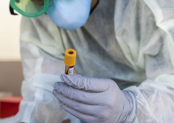 Navy Corpsmen with U.S. Naval Hospital Guam take samples from Sailors attached to USS Theodore Roosevelt for a CDC Study