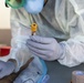 Navy Corpsmen with U.S. Naval Hospital Guam take samples from Sailors attached to USS Theodore Roosevelt for a CDC Study
