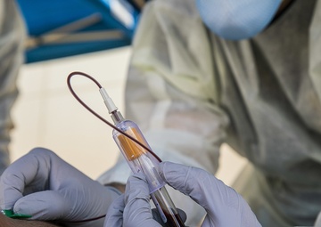 Navy Corpsmen with U.S. Naval Hospital Guam take samples from Sailors attached to USS Theodore Roosevelt for a CDC Study