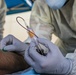Navy Corpsmen with U.S. Naval Hospital Guam take samples from Sailors attached to USS Theodore Roosevelt for a CDC Study
