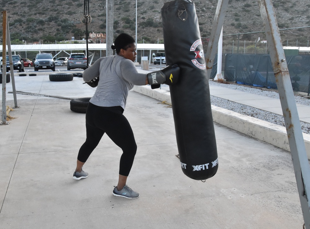 Religious Program Specialist 2nd Class Adjo Awoudja trains on a punching bag at NSA Souda Bay, Greece