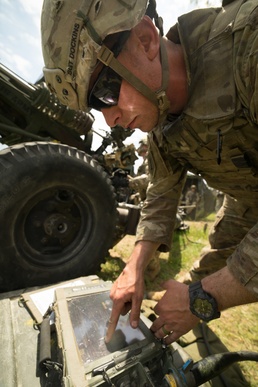 Howitzer section chief reads targets for fire mission