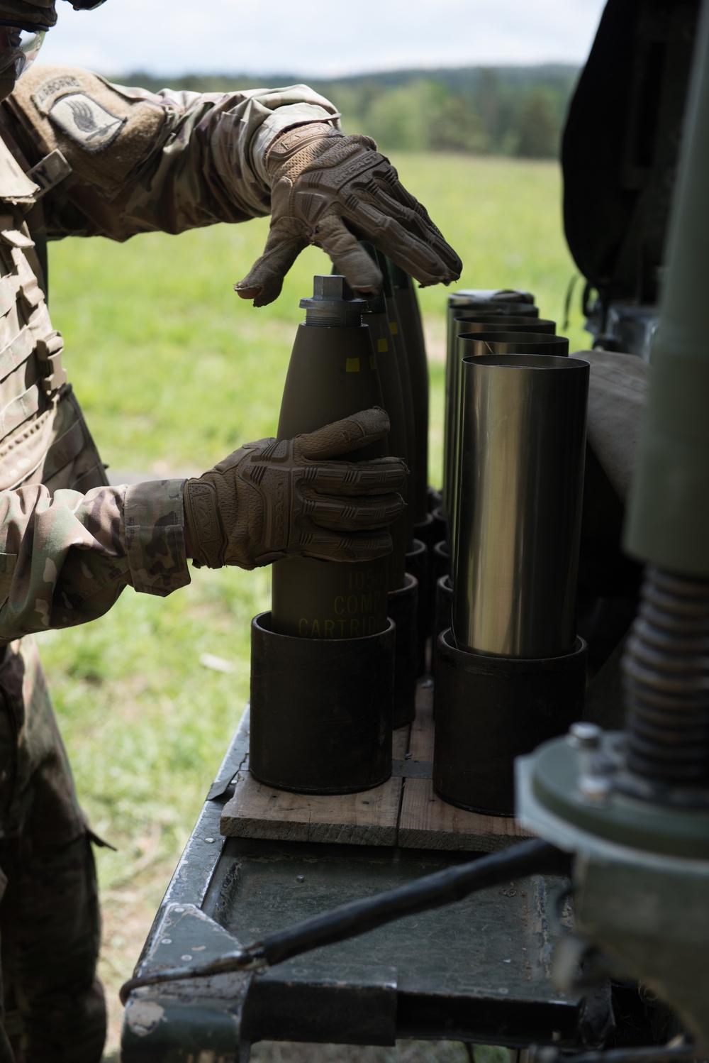 Paratrooper prepares howitzer round