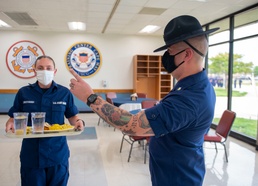 CAPE MAY, N.J. - Petty Officer 2nd Class Joshua Duran instructs recruit on proper galley procedure