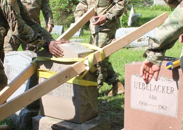 NY National Guard Soldiers repair World War 1 Guard Soldier's marker
