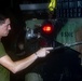 Sailors perform a vehicle wash down