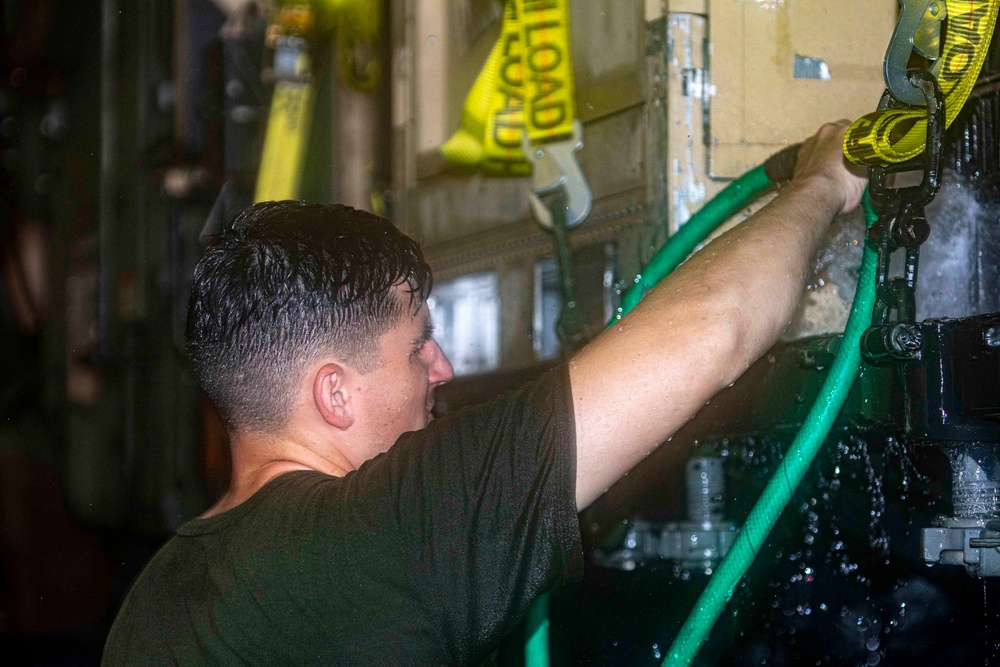 Sailors perform a vehicle wash down