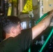 Sailors perform a vehicle wash down