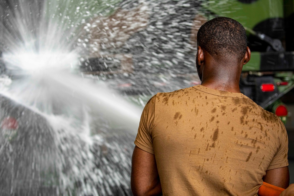 Sailors and Marines take part in vehicle wash down