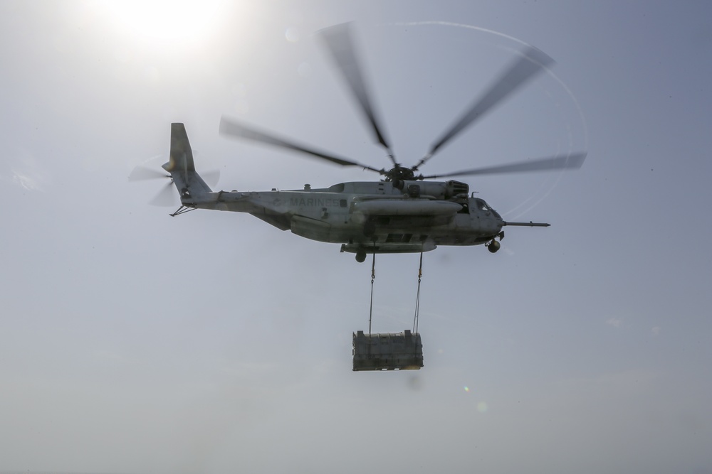 Helicopter support team transports AV-8B Harrier engine from USS Bataan