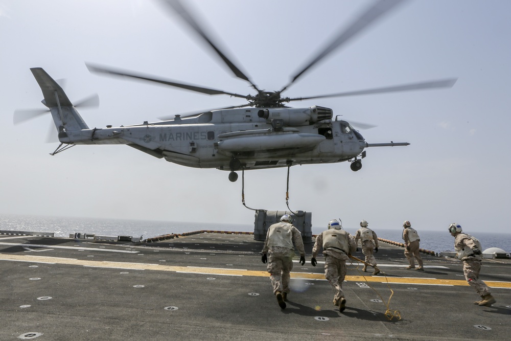 Helicopter support team transports AV-8B Harrier engine from USS Bataan