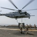 Helicopter support team transports AV-8B Harrier engine from USS Bataan