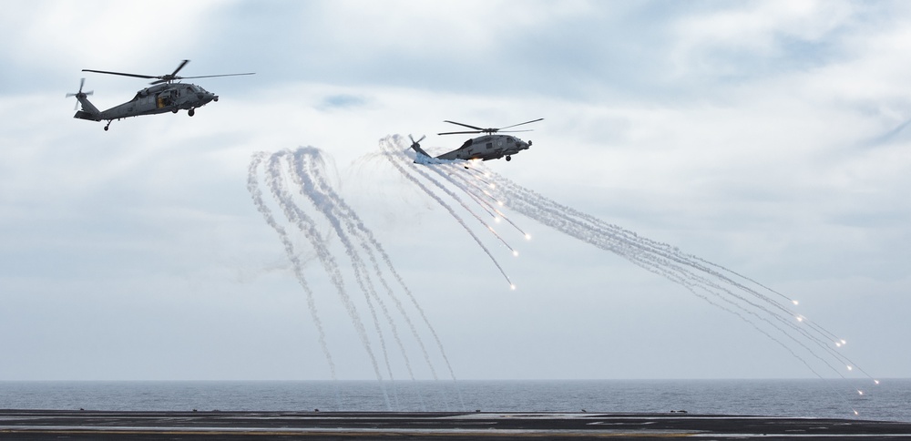 Nimitz CSG Helicopters Shoot Flares During Fly Over