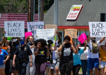 Texas Army National Guard Soldiers watch a peaceful protest in Baytown, TX