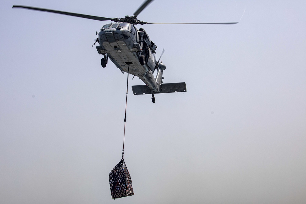 Sailors and Marines take part in a replenishment-at-sea