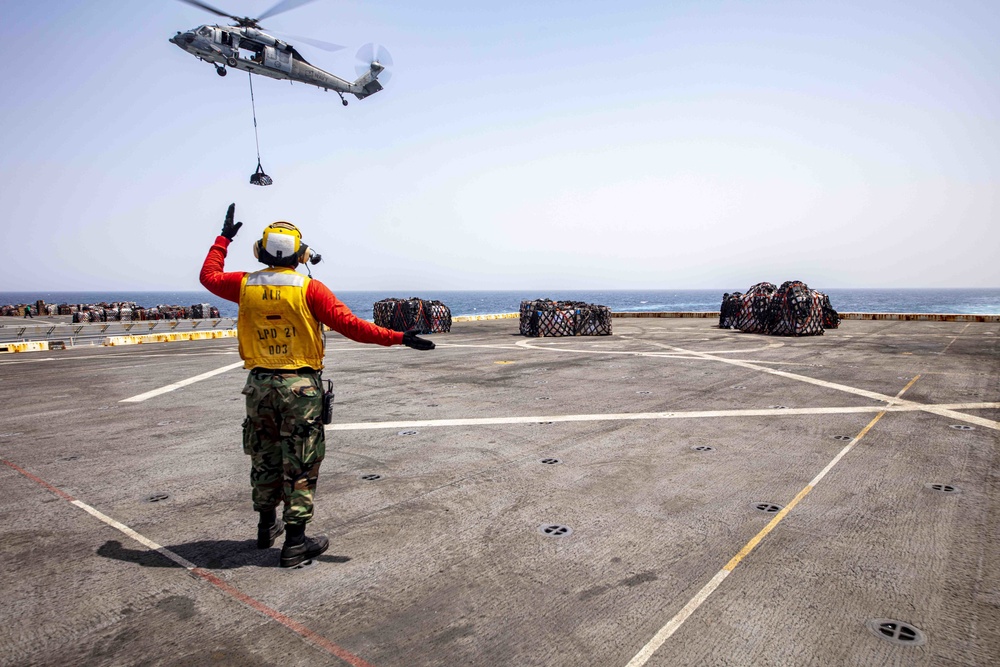 Sailors and Marines take part in a replenishment-at-sea