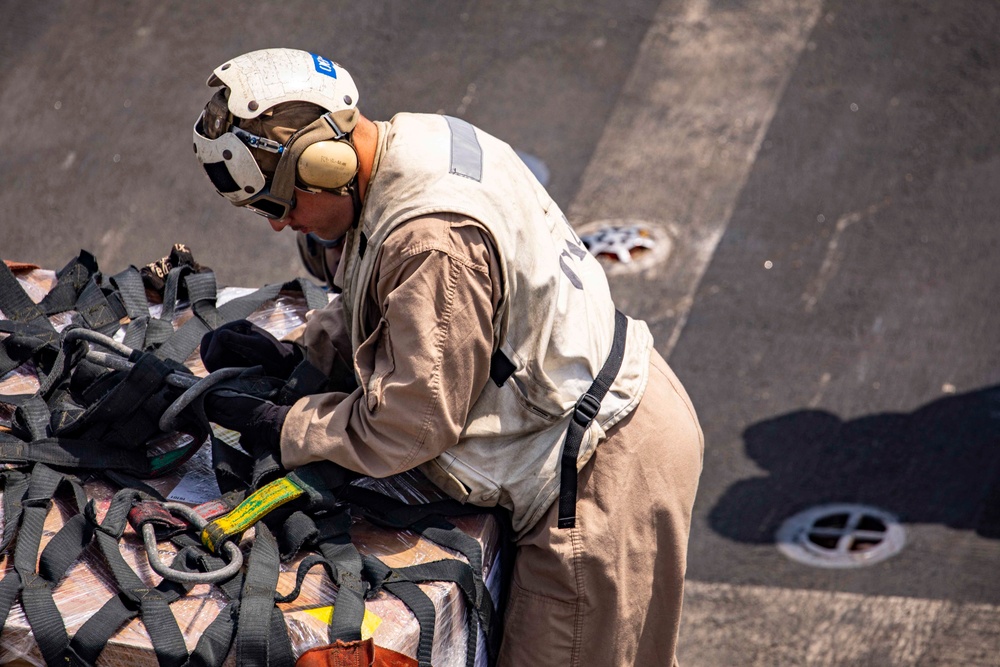 Sailors and Marines take part in a replenishment-at-sea