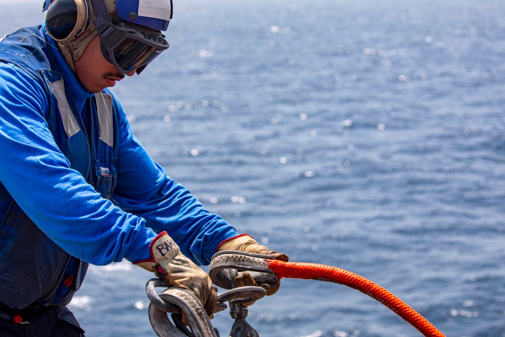 Sailors and Marines take part in a replenishment-at-sea