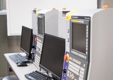 RIA factory team tours high school CNC program lab