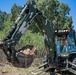 Seabees assigned to Naval Mobile Construction Battalion (NMCB) use a backhoe to excavate a trench during a street lighting construction project on aboard Naval Station Rota, Spain.