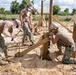 Seabees assigned to Naval Mobile Construction Battalion (NMCB) space and secure a log during an obstacle course construction project on aboard Naval Station Rota, Spain.