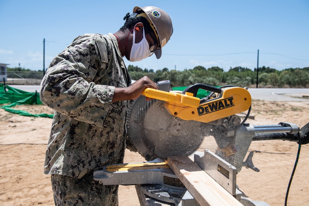 Seabees assigned to Naval Mobile Construction Battalion (NMCB) conduct a sewage line installation project for a kennel office building on board Naval Station Rota, Spain.