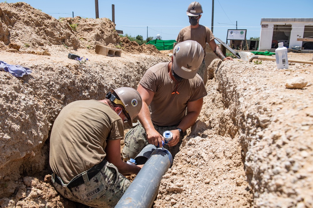 Seabees assigned to Naval Mobile Construction Battalion (NMCB) conduct a sewage line installation project for a kennel office building on board Naval Station Rota, Spain.