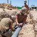 Seabees assigned to Naval Mobile Construction Battalion (NMCB) conduct a sewage line installation project for a kennel office building on board Naval Station Rota, Spain.