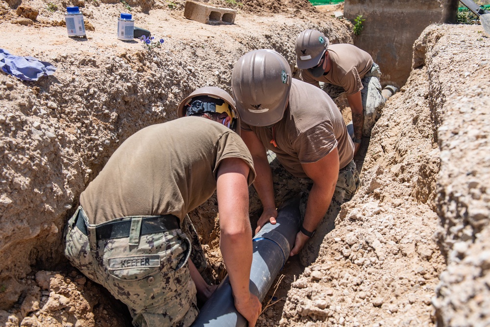 Seabees assigned to Naval Mobile Construction Battalion (NMCB) conduct a sewage line installation project for a kennel office building on board Naval Station Rota, Spain.