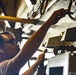 Sailors paint a bulkhead