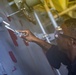 Sailors paint a bulkhead