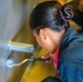 Sailors paint a bulkhead