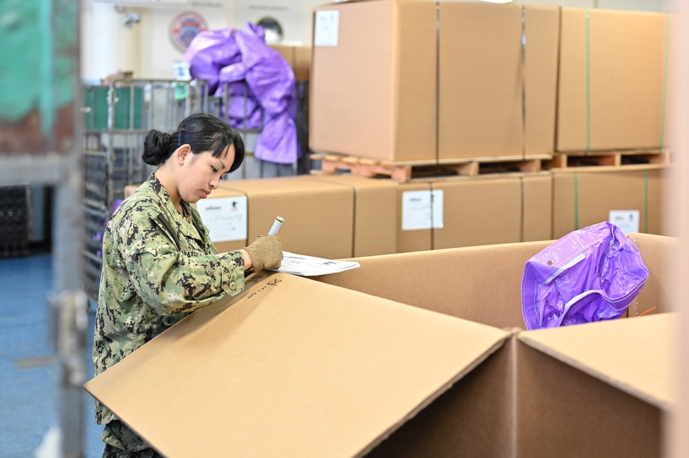 Naval Supply System Command Fleet Logistic Center Pearl Harbor prepares tri-wall postal packages for the Nimitz Carrier Strike Group