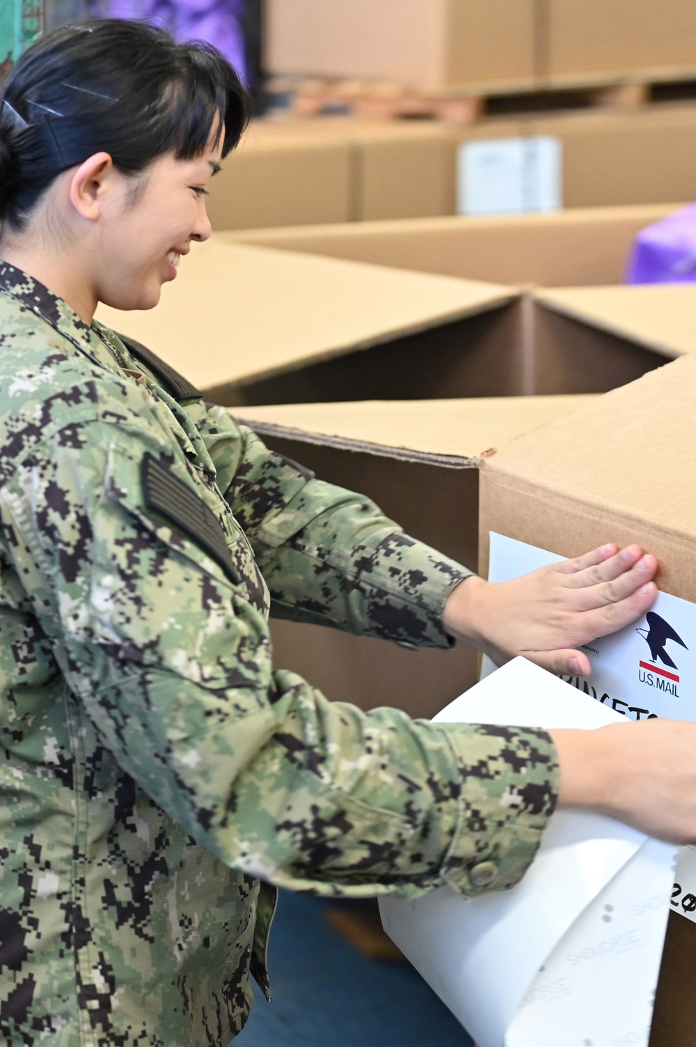 Naval Supply System Command Fleet Logistic Center Pearl Harbor prepares tri-wall postal packages for the Nimitz Carrier Strike Group