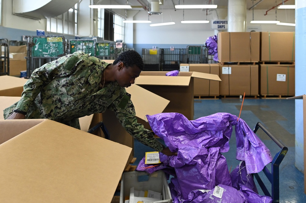 Naval Supply System Command Fleet Logistic Center Pearl Harbor prepares tri-wall postal packages for the Nimitz Carrier Strike Group