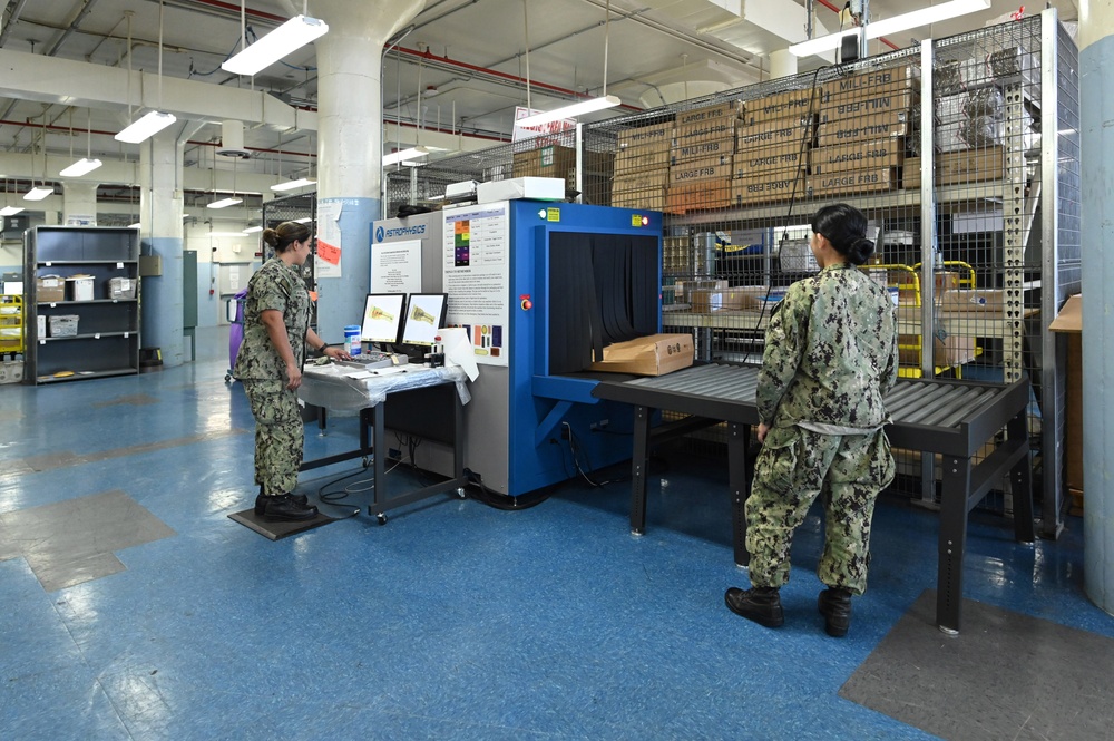 Naval Supply System Command Fleet Logistic Center Pearl Harbor prepares tri-wall postal packages for the Nimitz Carrier Strike Group